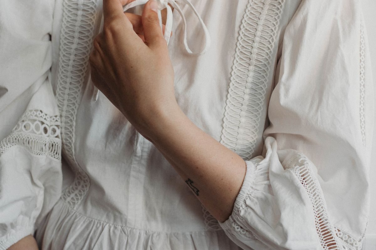 Detail of a white embroidered cotton dress