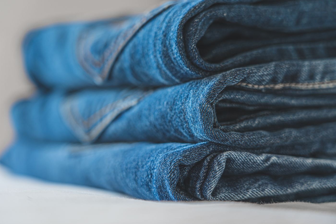 Folded blue denim jeans with visible stitching