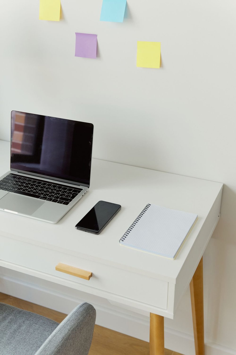 Laptop and notebook on a clear white desk