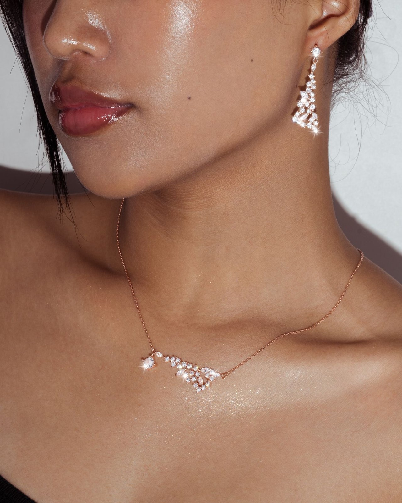 Drop earrings and a short necklace beside an open neckline