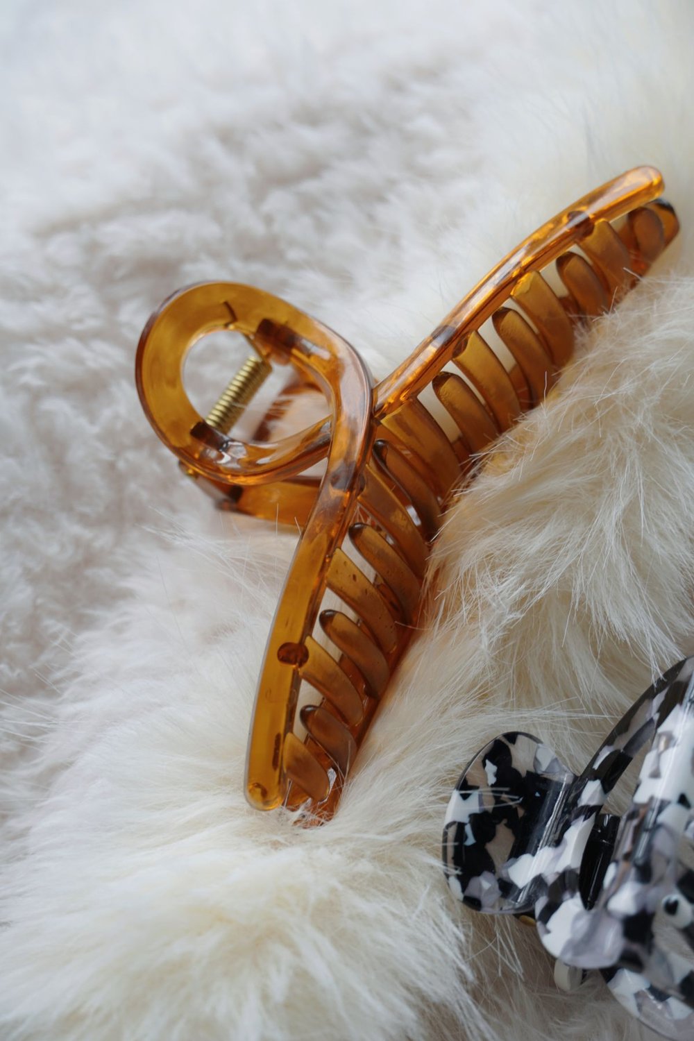 Claw hair clips resting on pale textured fabric
