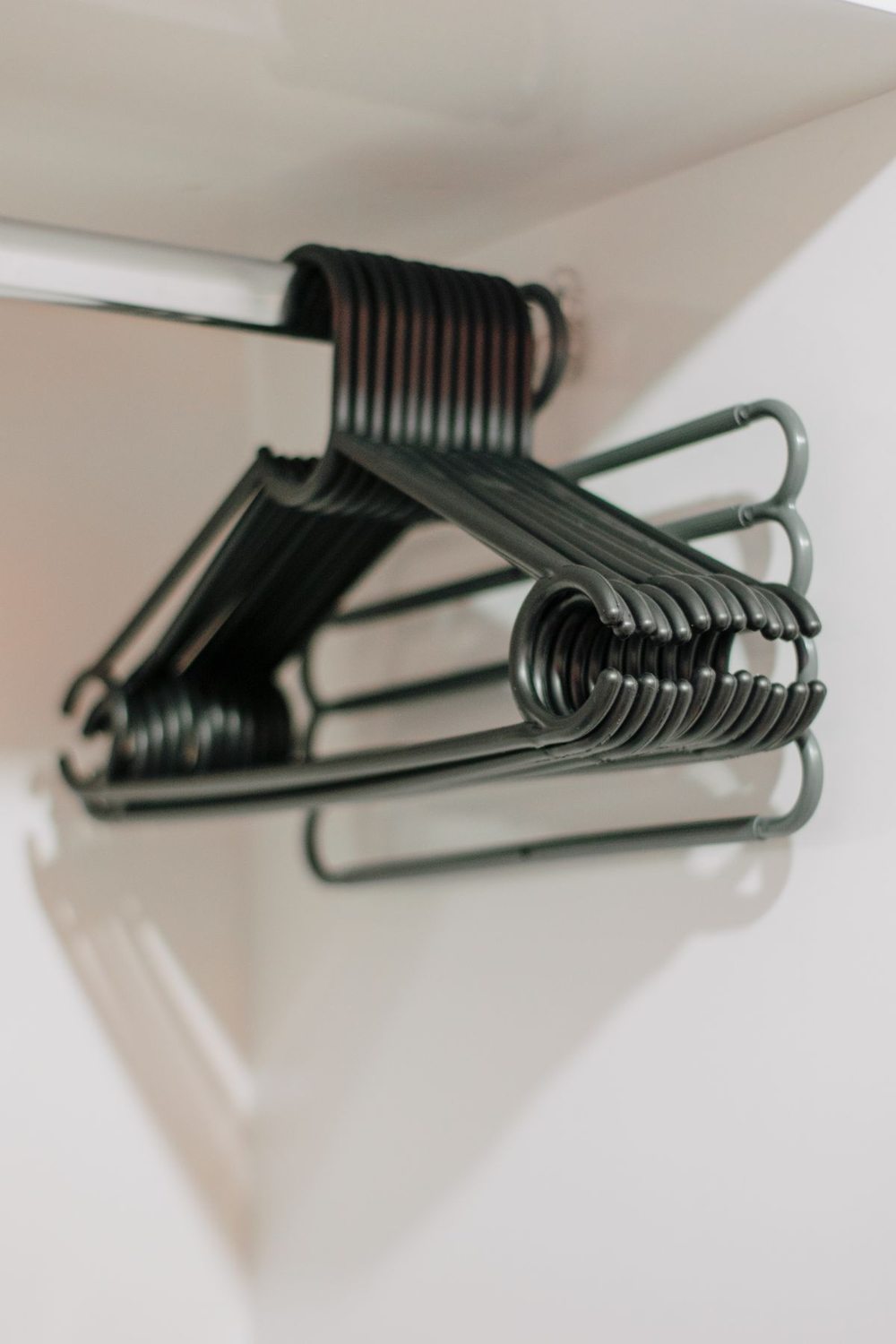Hangers spaced along a wardrobe rail