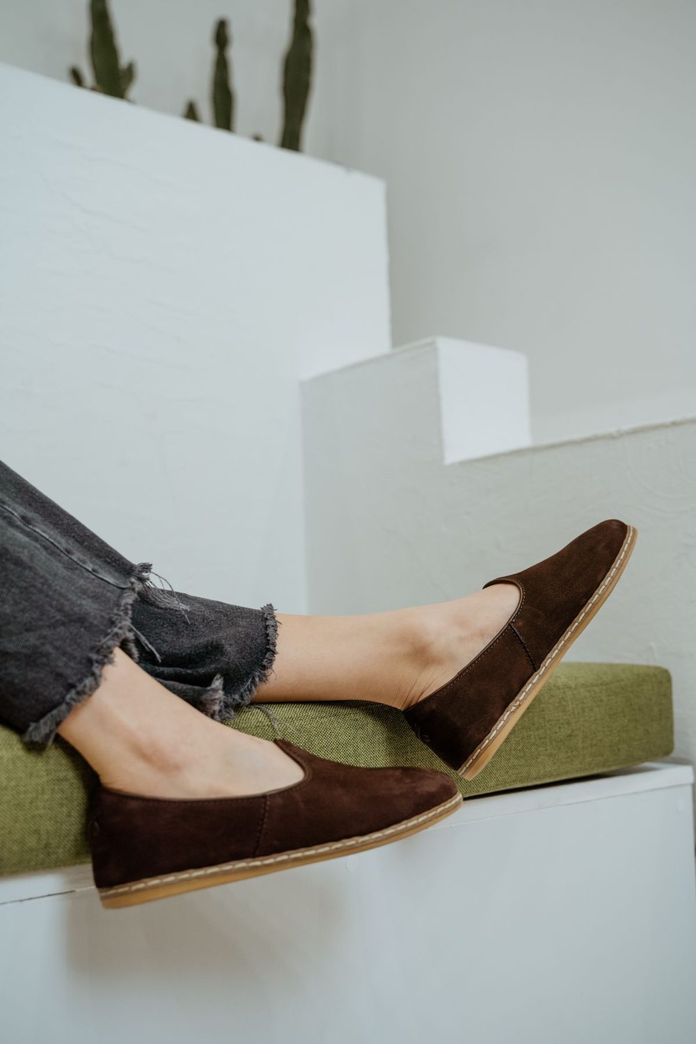 Brown loafers worn with blue jeans