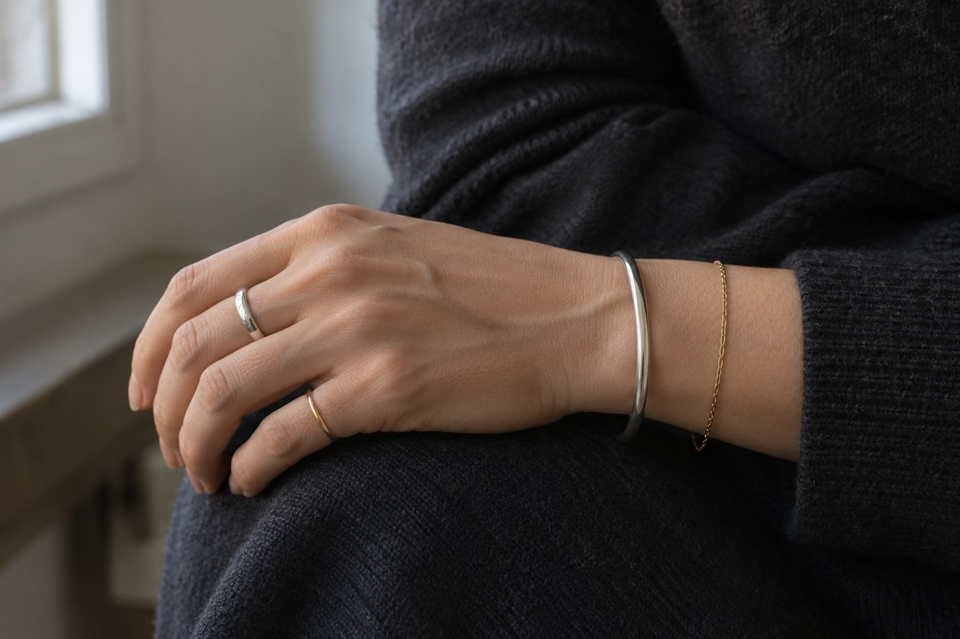 Silver and gold rings and bracelets worn together