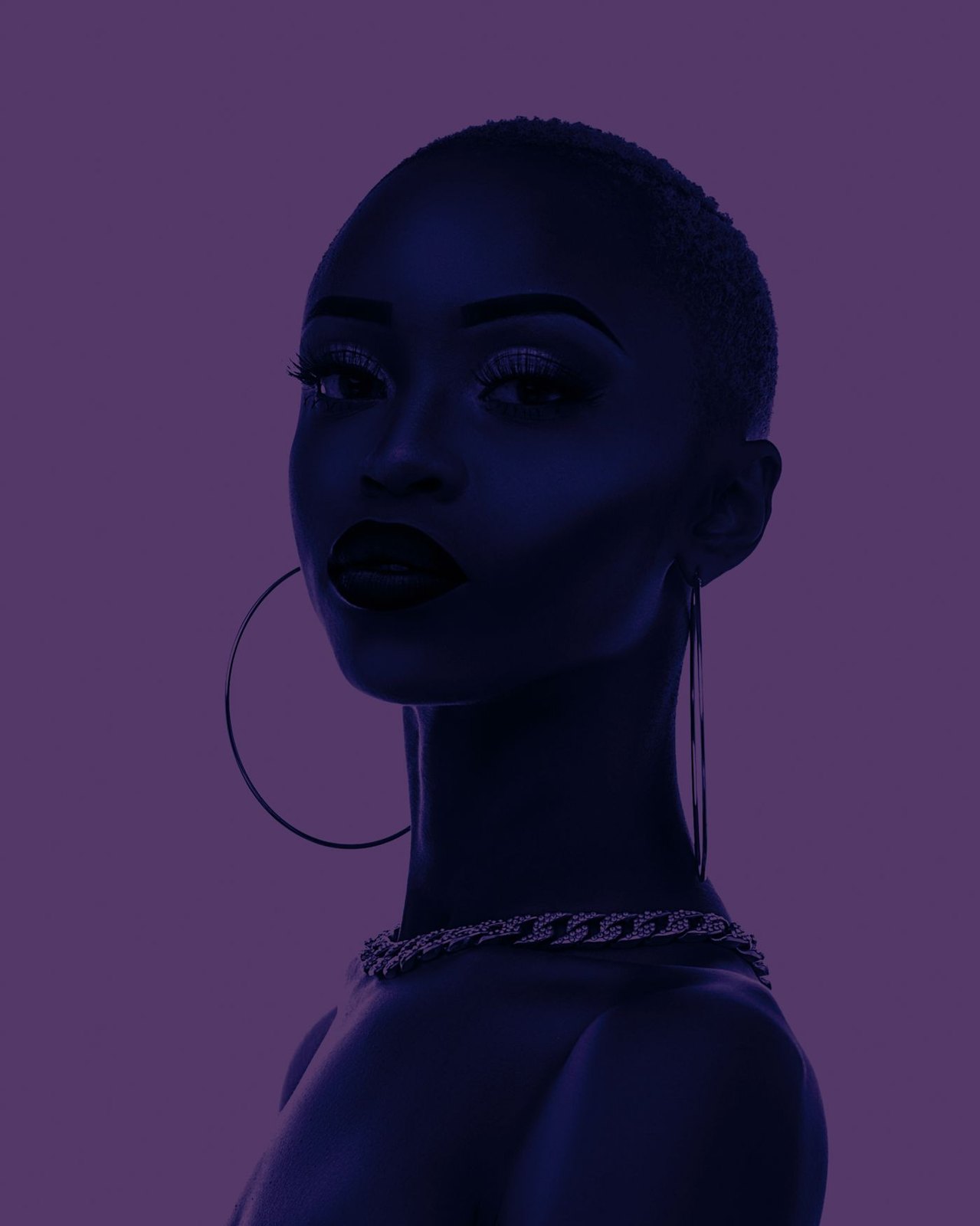 Large hoop earrings and a chain necklace in a fashion portrait