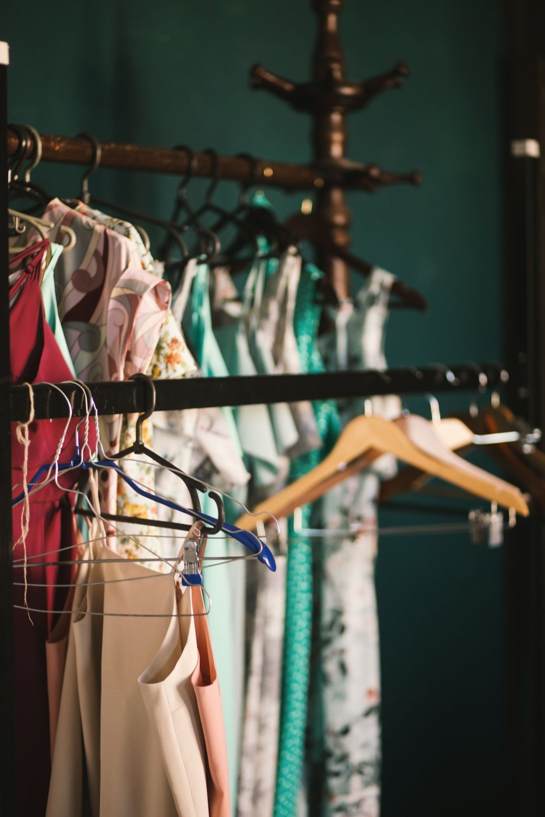 Dresses and shirts spaced along a clothing rail
