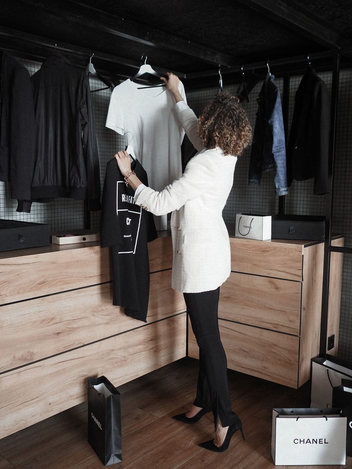 Woman adjusting clothes beside a mirror
