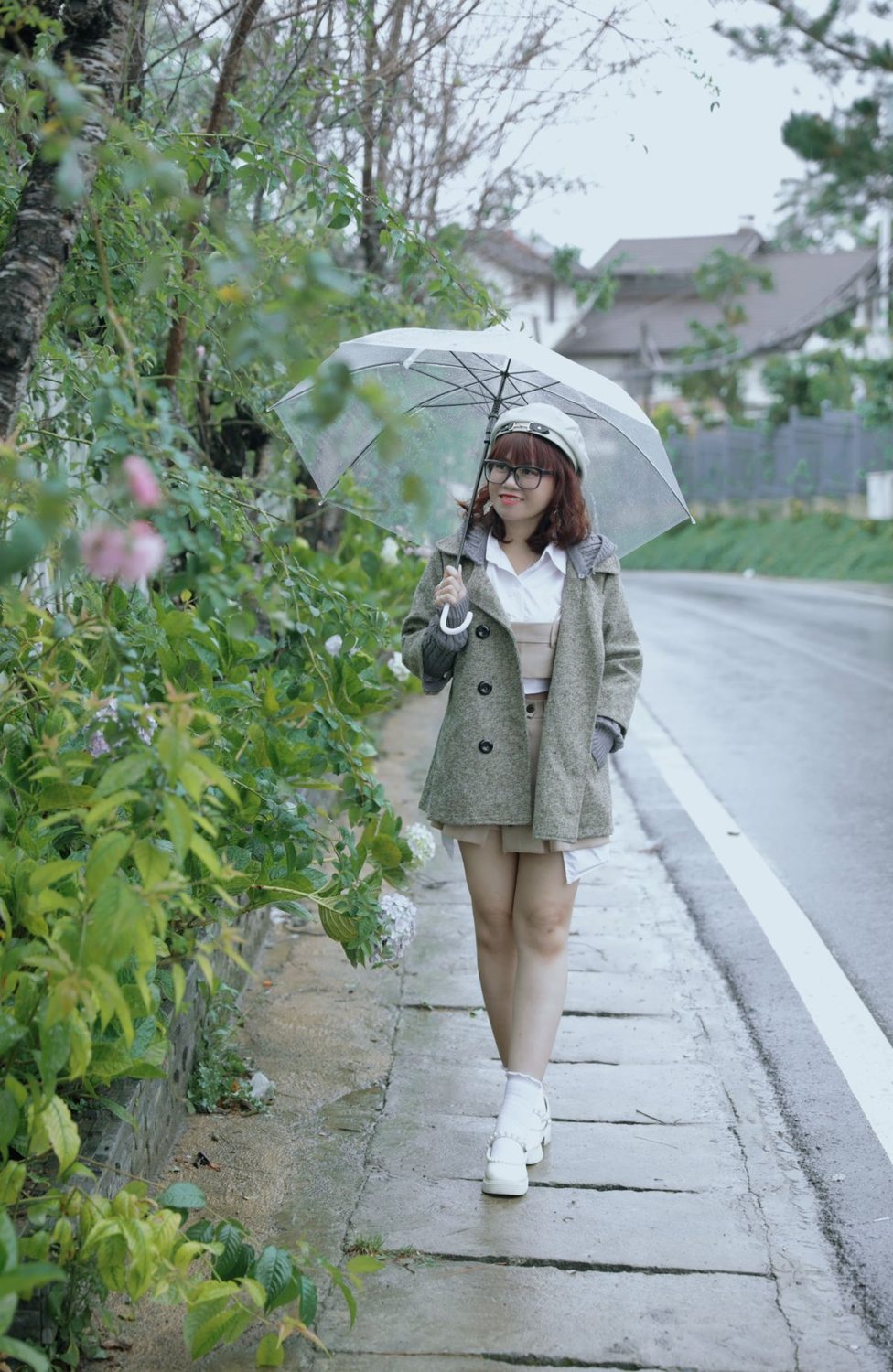 Woman wearing a coat and shorter hem while walking in the rain