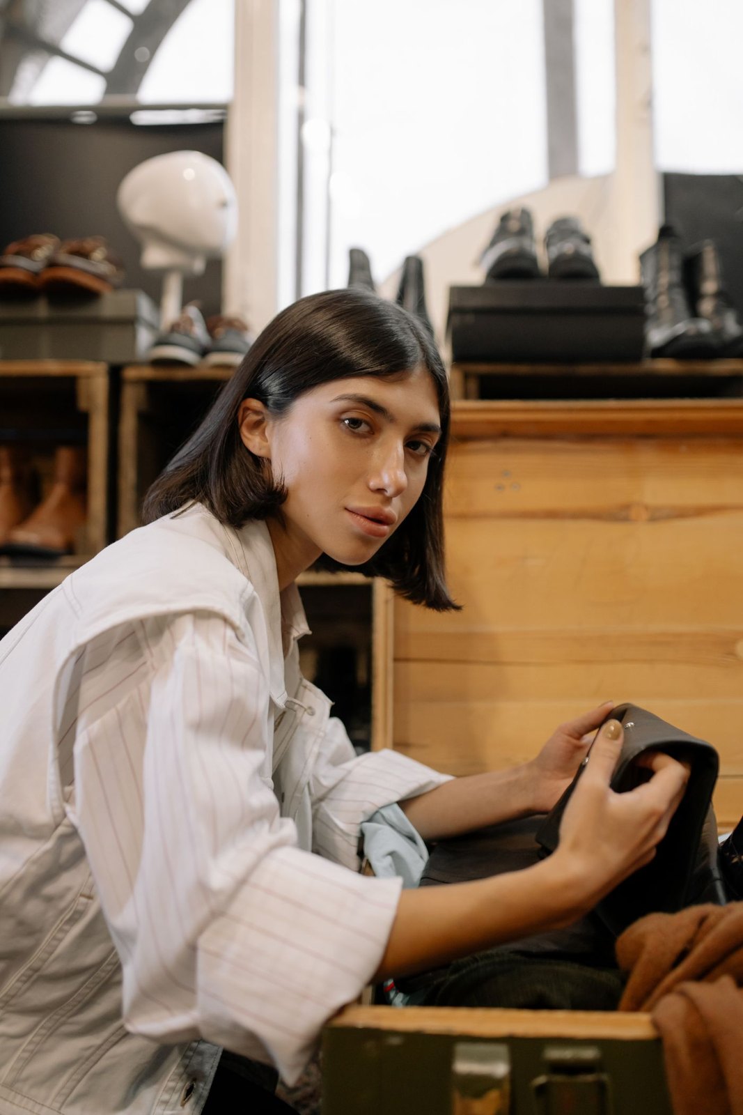 Woman inspecting a secondhand garment in a shop