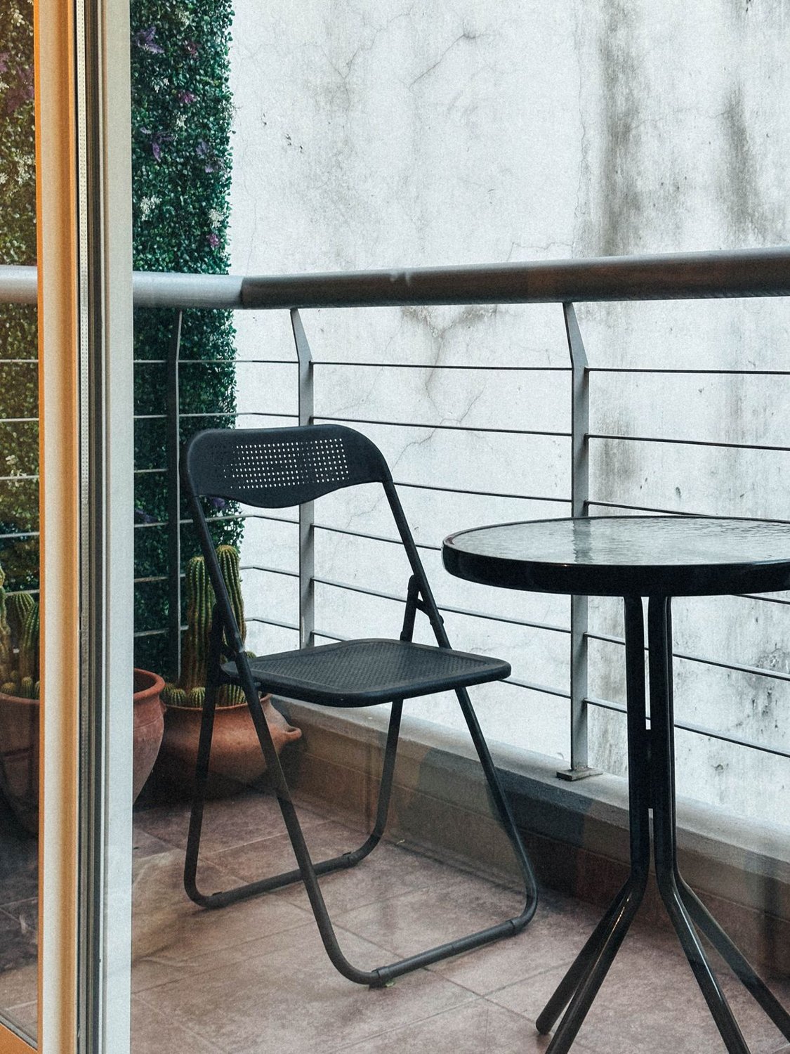 Chair and round table on a small balcony