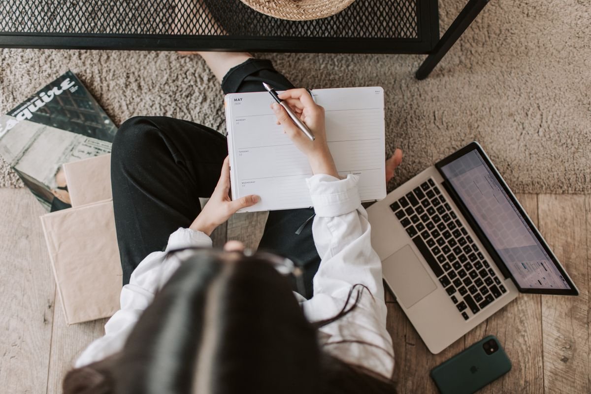 Woman making a plan in a notebook at home