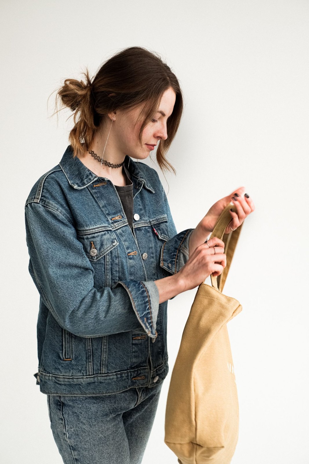 Woman looking inside a canvas tote bag