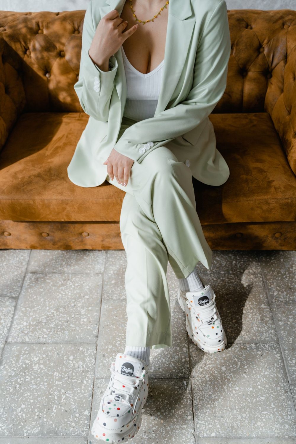 Green tailored suit worn with white trainers