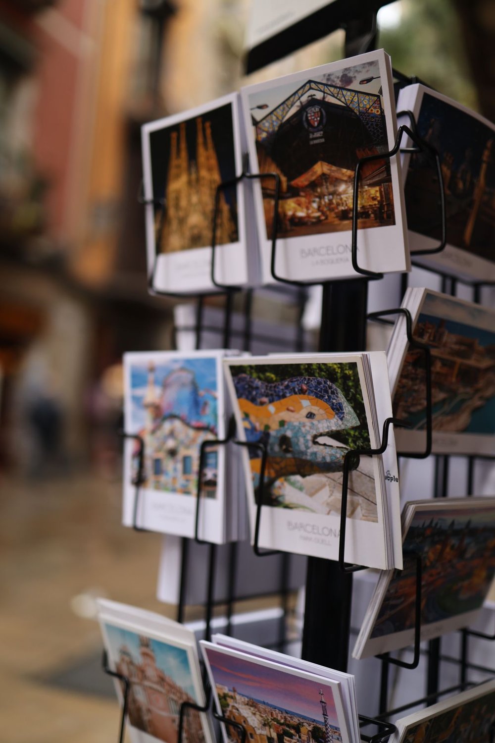 Postcards displayed on a rack at a souvenir shop