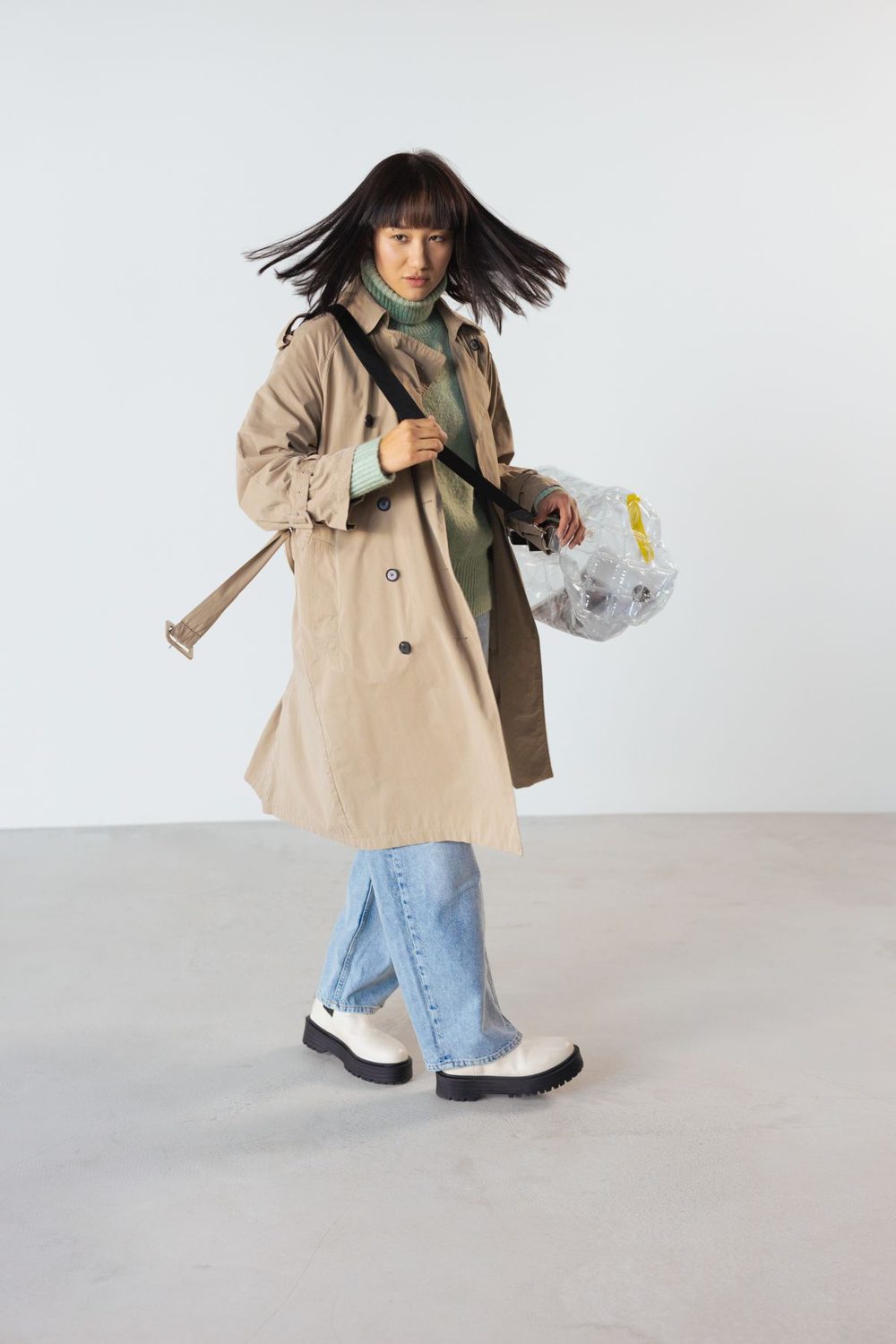Open brown trench coat over a simple denim outfit