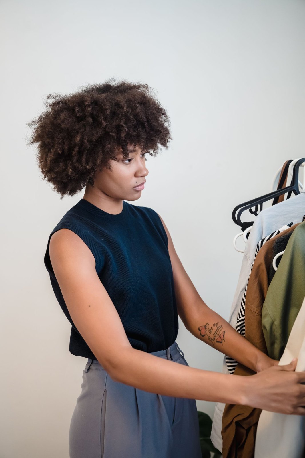 Woman looking through clothes on a rail