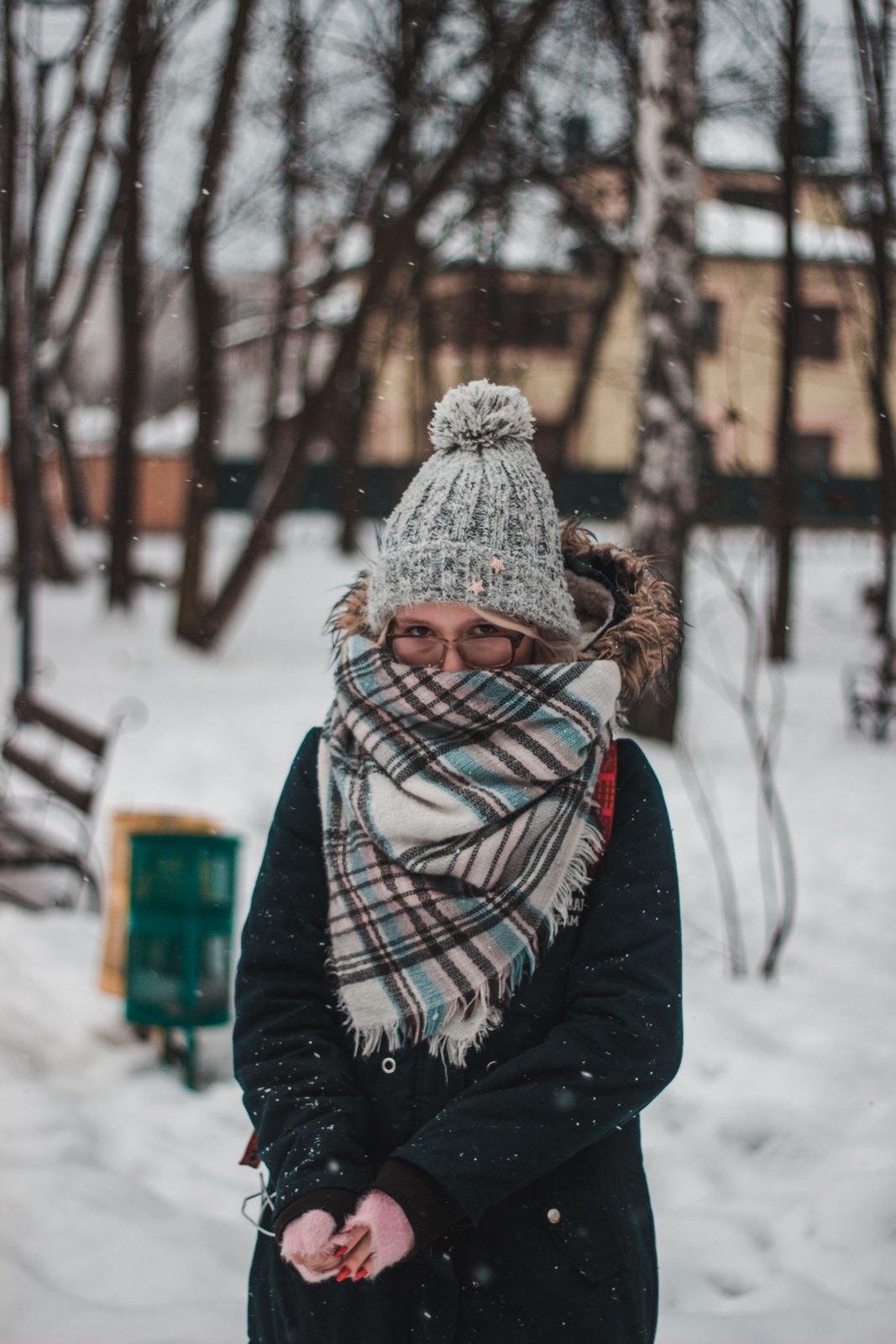 Woman wearing a thick scarf with a winter coat